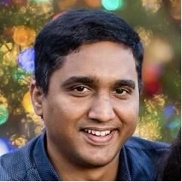 A image of a concrete sphere, balanced between two other larger spheres